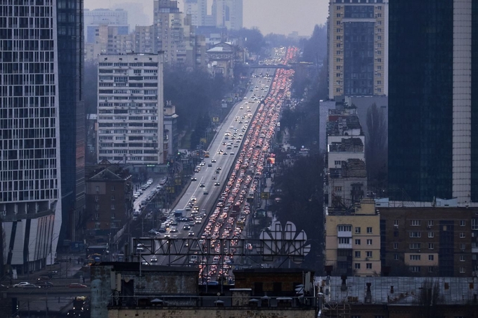 Refugees flee Kyiv, the Ukrainian capital, during Russia’s 2022 invasion. (Photo via CNN)